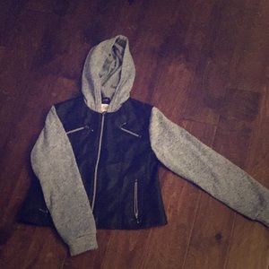 . ° black faux leather w/ knit sleeves.